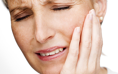 Mature woman with tooth ache