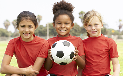 3 Children and a soccer ball