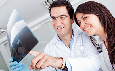 A male dentist looking at an x-ray