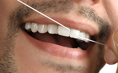 A man flossing his teeth