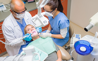 dentist doing a dental procedure on a female patient