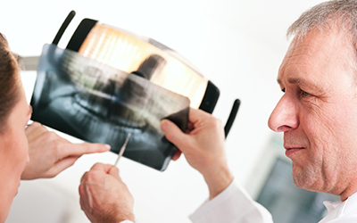 Dentist looking at an x-ray