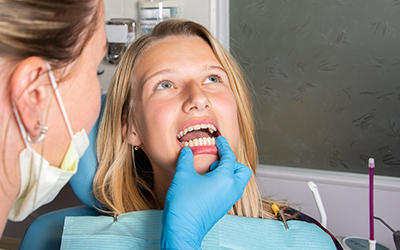 A doctor looking at a patients mouth