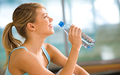 A woman drinking bottled water