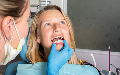 Dentist looking at a womans teeth