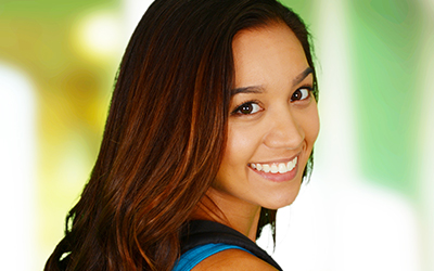 A teen girl smiling