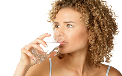 A woman drinking a glass of water