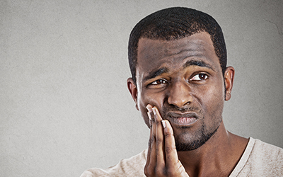 Male holding his jaw in pain